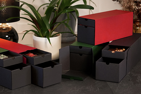 Several gift boxes with drawers and visible contents – Christmas packaging