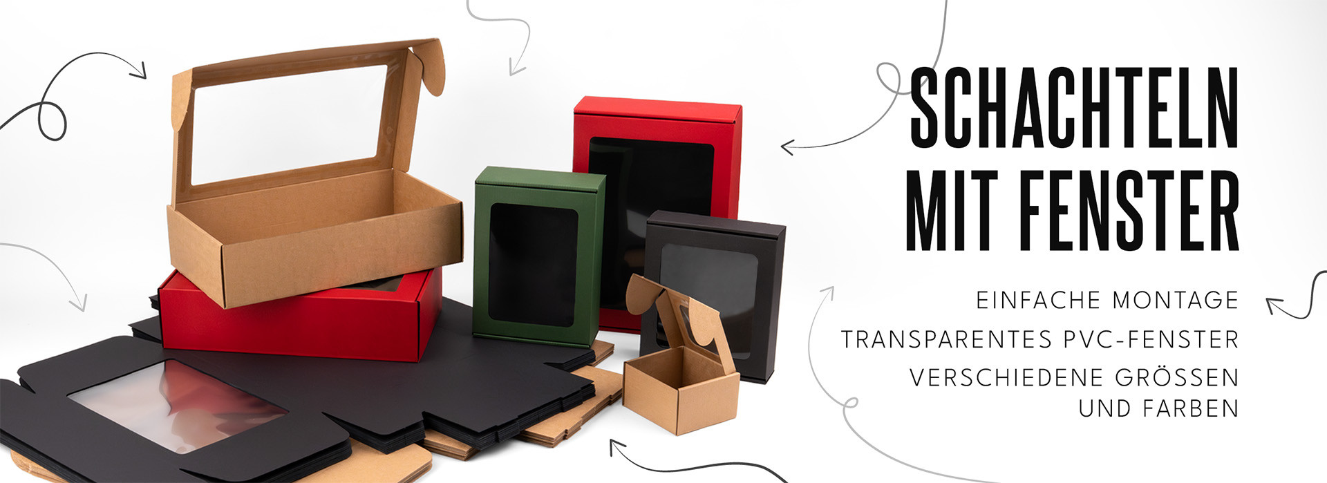 Kartonboxen in verschiedenen Größen und Farben mit transparenten PVC-Fenstern auf weißem Hintergrund.