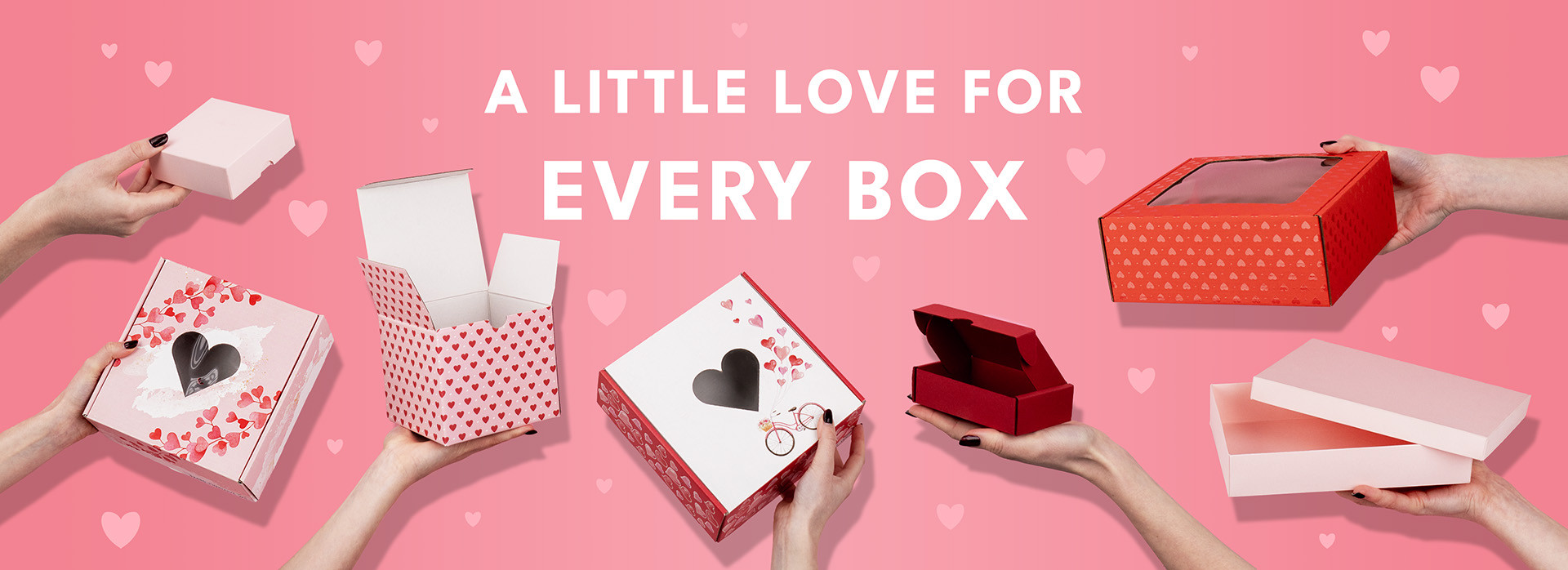Hands holding heart-decorated boxes against a pink background, conveying the message “A little love for every box”.